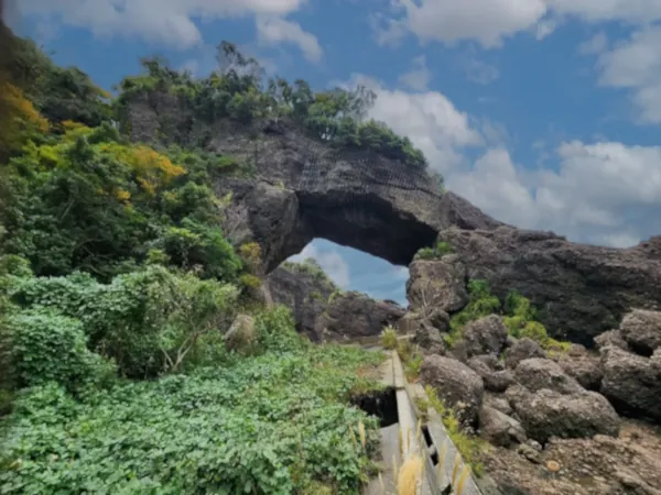 Stone arch with clouds at Tojinbo cliffs